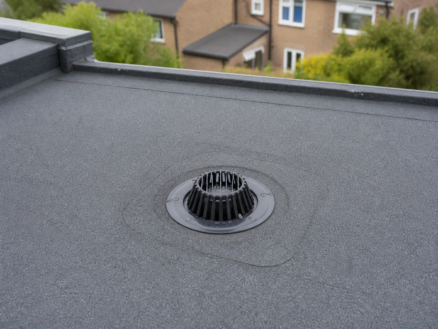 Clear drainage outlet on a maintained felt flat roof